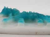 a white plate with blue crystals on top of it