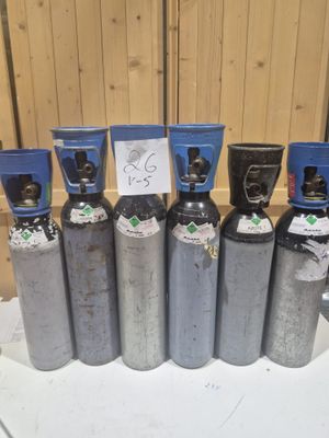 plusieurs types de bouteilles de gaz propane alignées sur une table