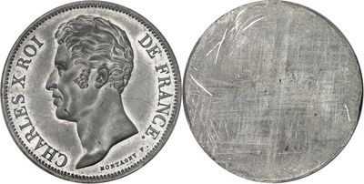 a close up of a silver coin with a face of a man on it