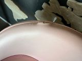 a close up of a pink chair in a room