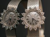 pair of ladies ' s wrist watches with diamonds on a silver bracelet