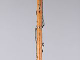 a clarinet with a wooden body and black and white markings