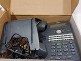 a box with a phone and other electronic items in it