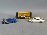 two toy cars are sitting next to each other on a table