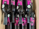 bottles of wine are in a cardboard box with labels on them
