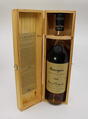 an empty bottle of alcohol in a wooden box