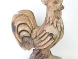 a wooden statue of a rooster on a white background
