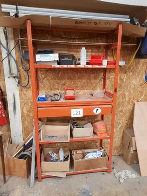 a shelf that has many boxes on it in a garage
