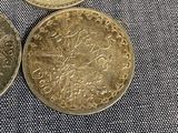 three coins sitting on top of each other on top of a cloth