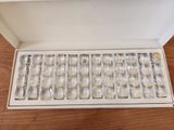 a box of silverware sitting on a wooden table