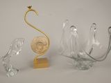 three pieces of glass and a gold sculpture on a table