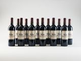 six bottles of wine lined up in a row on a white surface