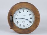 a wooden clock with roman numerals on the face