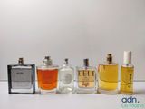 several different types of perfume bottles lined up on a white surface