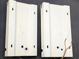 a pair of white metal brackets with wires attached to them
