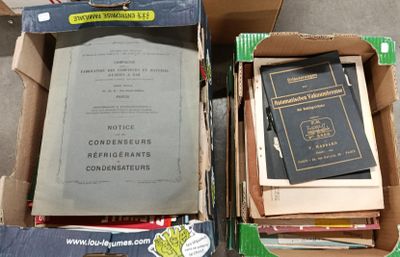 two boxes of books sitting on the floor next to each other