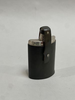 a lighter that is sitting on a white surface