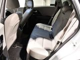 the back seats of a white car with a black seat belt