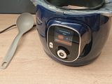 a blue pot with a spoon in it on a table