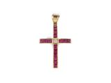 a gold cross pendant with ruby stones on a white background