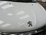 a white car parked in a parking lot next to a building