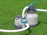 a water pump that is connected to a hose on the grass