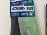 two microfiber cloths, a cleaning cloth, and a cleaning cloth on a white surface