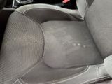 a dirty seat in the back of a car