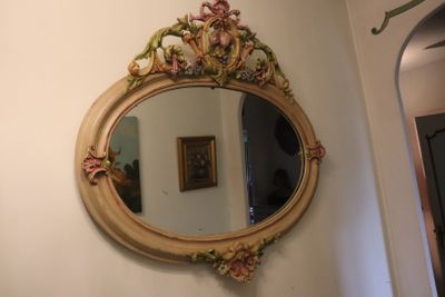 a mirror hanging on the wall above a sink
