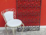 a chair and a chair that are sitting in front of a red wall