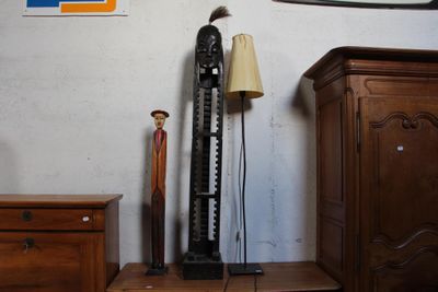 une horloge et une lampe posées sur une commode dans une pièce