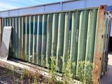 a large green container sitting on the side of the road