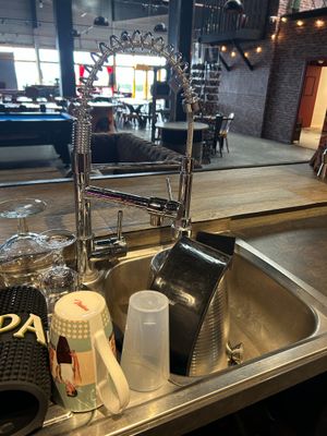 a sink that has a lot of items in it