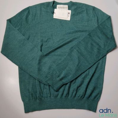 the sweater is green and has a white tag on it