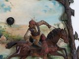 a statue of a man riding a horse on a wall