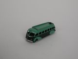 a toy bus that is sitting on a white surface