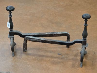 wrought iron bed frame with turned legs and foot rests on the floor