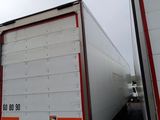 two trucks that are side by side on the road