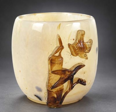 a glass cup with a picture of a woman and a bird on it