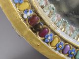 a close up of a mirror with a lot of beads on it