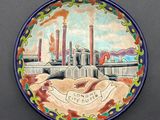 a plate with a picture of a factory on it