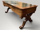 an old wooden table with a glass top on a gray background