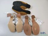 three pairs of women ' s shoes and a pair of gloves on a table