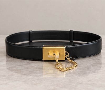 a close up of a black belt with a gold buckle