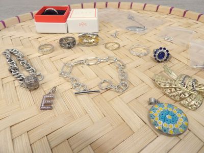 a lot of jewelry sitting on a table on the floor