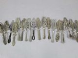 a lot of silver spoons and spoons on a white surface
