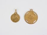 two small gold medallions with the letter s on them
