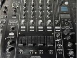 a dj mixer sitting on top of a table