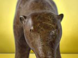a statue of a bear that is standing on a table