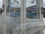 a large white building with a lot of plastic covering it